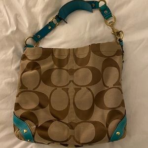 Coach tote with turquoise accents.
